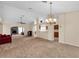 Open living room with high ceilings and a view of the fireplace at 815 Forest Breeze Path, Leesburg, FL 34748
