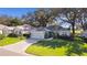 Single-story home with paved driveway and green lawn at 8194 Se 177Th Winterthur Loop, The Villages, FL 32162