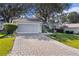 Beautiful home exterior with a paver driveway and landscaping at 8194 Se 177Th Winterthur Loop, The Villages, FL 32162