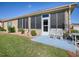 Screened-in patio with seating area and lush landscaping at 9470 Se 130Th Street Rd, Summerfield, FL 34491