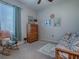 Guest bedroom with a daybed and rocking chair at 9470 Se 130Th Street Rd, Summerfield, FL 34491