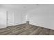 Simple bedroom with wood-look floors and neutral walls at 25013 Van Buren St, Astatula, FL 34705