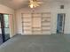 Spacious living room with built-in shelving and access to a sunroom at 2494 County Road 447, Lake Panasoffkee, FL 33538