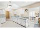 Kitchen boasts white cabinetry, a skylight, and a light blue countertop at 2411 Greenlaw Ct, Leesburg, FL 34788