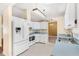 White kitchen with stainless steel appliances and a breakfast bar at 2411 Greenlaw Ct, Leesburg, FL 34788