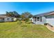 Spacious backyard with grassy area and mature trees at 2411 Greenlaw Ct, Leesburg, FL 34788