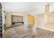 Spacious living room with vaulted ceilings, wood-look floors, and built-in shelving at 2411 Greenlaw Ct, Leesburg, FL 34788