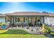 Ranch home showcasing a screened porch, attractive landscaping and a two-car garage at 2411 Greenlaw Ct, Leesburg, FL 34788