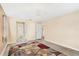 Large bedroom with ceiling fan and access to bathroom at 2411 Greenlaw Ct, Leesburg, FL 34788