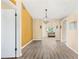 Spacious dining area with wood-look floors and an accent wall at 2411 Greenlaw Ct, Leesburg, FL 34788