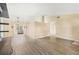 Living room showcasing vaulted ceilings, wood-look flooring and an open floor plan at 2411 Greenlaw Ct, Leesburg, FL 34788