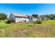 Large backyard with grassy area and partial view of house at 2411 Greenlaw Ct, Leesburg, FL 34788