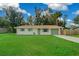 One-story house with green lawn and wooden fence at 5246 Se 108Th Pl, Belleview, FL 34420
