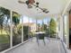 Bright sunroom with glass walls, ceiling fan, and table with chairs at 3358 Quail Hollow Ct, The Villages, FL 32163