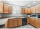 Kitchen with light wood cabinets, stainless steel appliances, and granite countertops at 3358 Quail Hollow Ct, The Villages, FL 32163