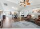 Open living area with hardwood floors, leather furniture, and access to the backyard at 3358 Quail Hollow Ct, The Villages, FL 32163