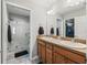 Double vanity bathroom with wood cabinets and shower at 3358 Quail Hollow Ct, The Villages, FL 32163