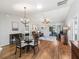 Open concept dining area with hardwood floors and chandelier at 3358 Quail Hollow Ct, The Villages, FL 32163