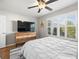 Bedroom with large TV, dresser, and window with shutters at 3358 Quail Hollow Ct, The Villages, FL 32163