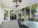 Screened porch with table, chairs, and view of backyard at 3358 Quail Hollow Ct, The Villages, FL 32163