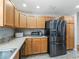 Kitchen with light wood cabinets, stainless steel appliances, and granite countertops at 3358 Quail Hollow Ct, The Villages, FL 32163