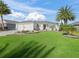 Single-story home with two-car garage and manicured lawn at 3358 Quail Hollow Ct, The Villages, FL 32163