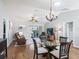 Open concept dining area with hardwood floors and chandelier at 3358 Quail Hollow Ct, The Villages, FL 32163