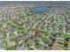 Aerial view of a home community with lake and lush landscaping at 3358 Quail Hollow Ct, The Villages, FL 32163