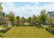 Landscaped green space in community with trees and benches at 10156 Ballast Dr, Orlando, FL 32827
