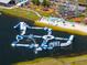 Aerial view of a resort-style community with a lake, playground, and obstacle course at 10156 Ballast Dr, Orlando, FL 32827