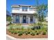 Two-story house with light-colored siding, a gray roof, and a teal door at 10425 Medawar St, Orlando, FL 32827