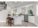Elegant wet bar with granite countertop and wine cooler at 17601 Sawgrass Run, Tavares, FL 32778