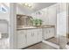Double vanity bathroom with large mirror and white cabinets at 17601 Sawgrass Run, Tavares, FL 32778