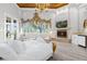 Opulent main bedroom with fireplace, wet bar, and water views at 17601 Sawgrass Run, Tavares, FL 32778