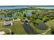 Bird's-eye view showcasing the home's waterfront setting and dock at 17601 Sawgrass Run, Tavares, FL 32778