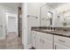 Bathroom with granite countertop and walk-in shower at 17601 Sawgrass Run, Tavares, FL 32778