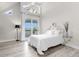 Bright bedroom with water views and access to a private balcony at 17601 Sawgrass Run, Tavares, FL 32778