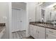 Elegant bathroom with double vanity and walk-in shower at 17601 Sawgrass Run, Tavares, FL 32778