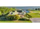 Luxury waterfront home with private dock and lush landscaping at 17601 Sawgrass Run, Tavares, FL 32778