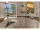 Spacious walk-in shower with multiple shower heads and a built-in seat at 17601 Sawgrass Run, Tavares, FL 32778