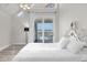Bright bedroom with water view and access to balcony at 17601 Sawgrass Run, Tavares, FL 32778