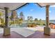 Relaxing patio with lake views and pool access at 17601 Sawgrass Run, Tavares, FL 32778
