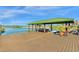 Private boat dock with covered storage and paddleboards at 17601 Sawgrass Run, Tavares, FL 32778