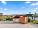 Outdoor brick grill with a lake view at 17601 Sawgrass Run, Tavares, FL 32778