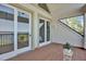 Spacious balcony with water views and brick flooring at 17601 Sawgrass Run, Tavares, FL 32778