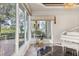 Bright music room with large windows and views of the water at 17601 Sawgrass Run, Tavares, FL 32778