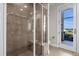 Walk-in shower with glass enclosure and built-in seat at 17601 Sawgrass Run, Tavares, FL 32778