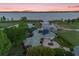 Lakefront property with solar panels, showcasing sunset views at 17601 Sawgrass Run, Tavares, FL 32778