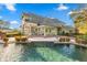 Stunning pool and patio area overlooking the lake at 17601 Sawgrass Run, Tavares, FL 32778