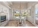 Bright breakfast nook with a fireplace and lake views at 17601 Sawgrass Run, Tavares, FL 32778